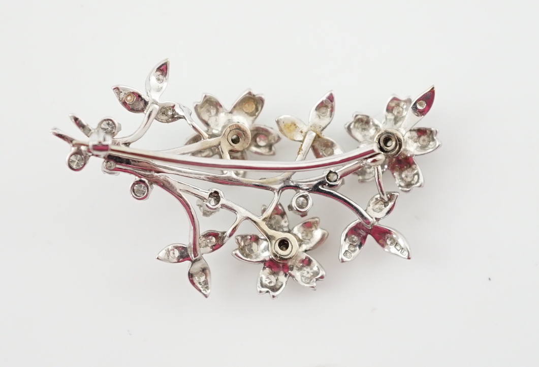 A 1960's 18ct white gold and diamond cluster set floral spray brooch